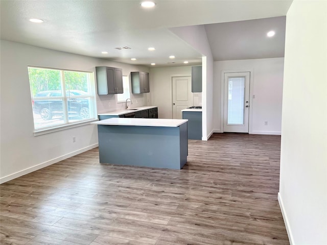 803 Hackberry St, Stafford, TX 77477 - kitchen with gray cabinetry, baseboards, wood finished floors, a sink, and recessed lighting