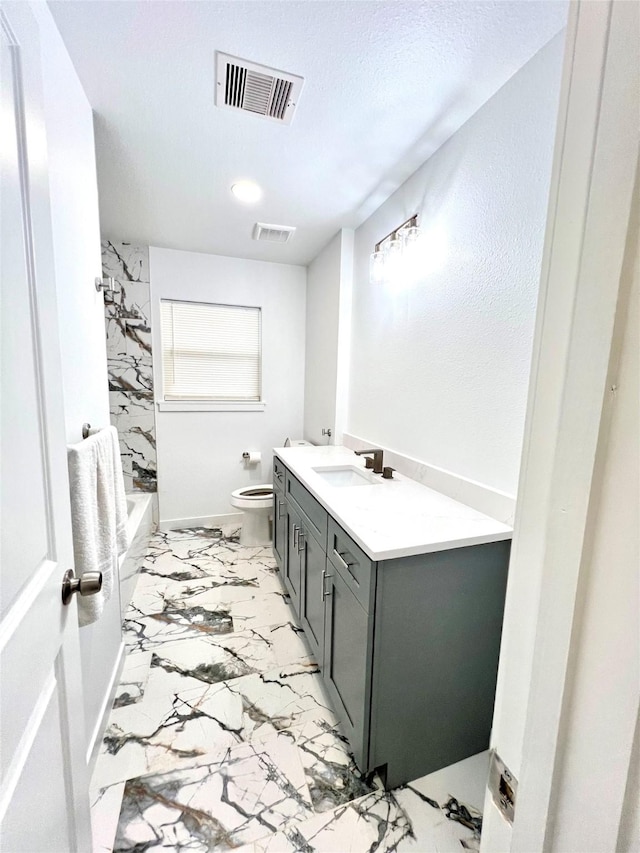 803 Hackberry St, Stafford, TX 77477 - bathroom with marble look tiles, toilet, vanity, and washtub / shower combination