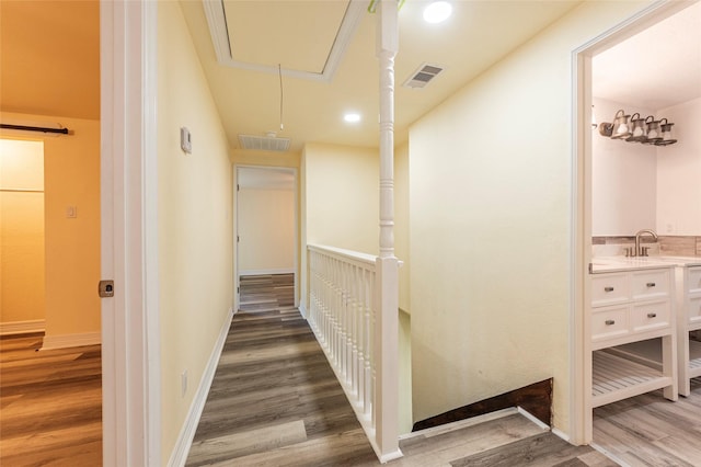 1535 Scott St, La Marque, TX 77568 - hall with wood finished floors, attic access, recessed lighting, and baseboards