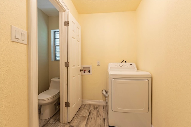 1535 Scott St, La Marque, TX 77568 - washroom featuring washer / clothes dryer, light wood finished floors, and baseboards