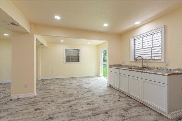 1535 Scott St, La Marque, TX 77568 - kitchen with a sink, light wood finished floors, recessed lighting, and baseboards