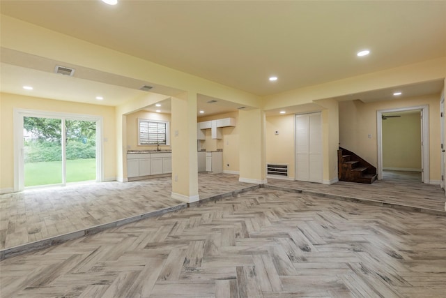 1535 Scott St, La Marque, TX 77568 - unfurnished living room featuring stairway, a sink, baseboards, and recessed lighting