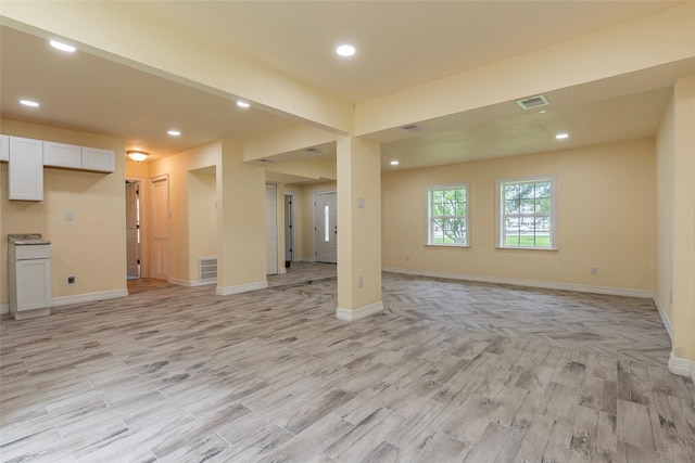 1535 Scott St, La Marque, TX 77568 - unfurnished living room with light wood-style floors, baseboards, and recessed lighting