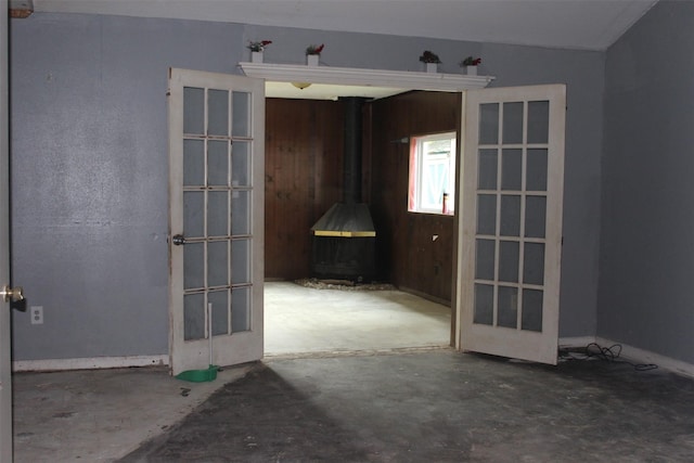 814 Kilpatrick St, Channelview, TX 77530 - unfurnished living room featuring a wood stove and unfinished concrete floors
