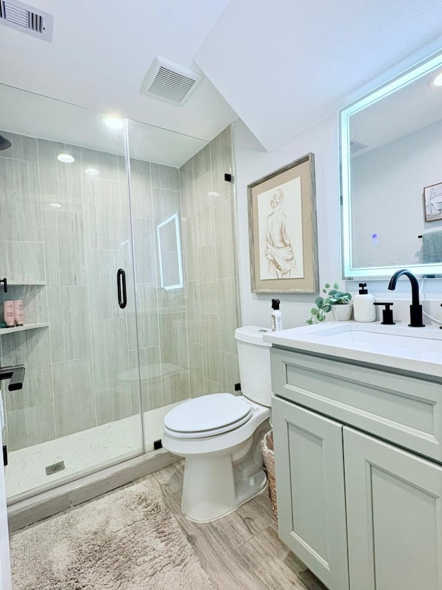 55 Ruskin Dr W, Montgomery, TX 77356 - full bath featuring vanity, a shower stall, toilet, and wood finished floors