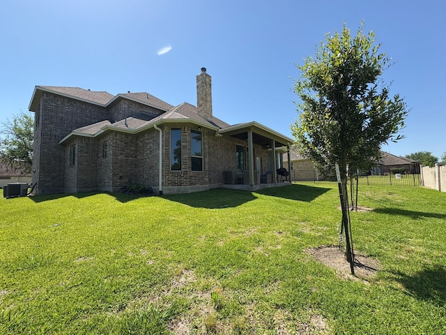 55 Ruskin Dr W, Montgomery, TX 77356 - back of property with central AC, brick siding, and a chimney