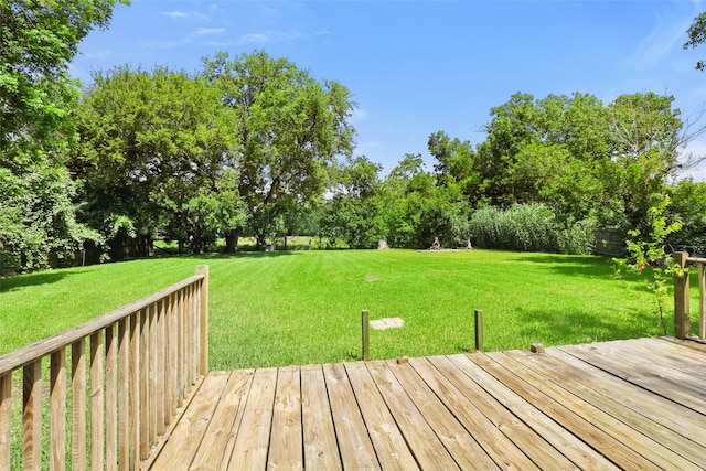 700 Ross St, La Marque, TX 77568 - wooden terrace with a lawn and view of wooded area