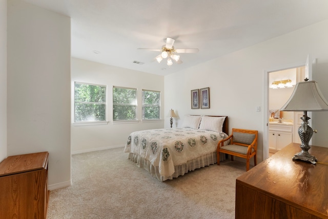 6510 Hoads Deuce Ct, Spring, TX 77379 - bedroom with light carpet, baseboards, ensuite bath, and a ceiling fan