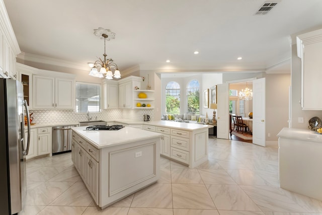 6510 Hoads Deuce Ct, Spring, TX 77379 - kitchen featuring a chandelier, appliances with stainless steel finishes, healthy amount of natural light, a sink, and crown molding