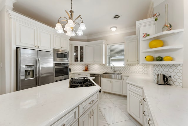 6510 Hoads Deuce Ct, Spring, TX 77379 - kitchen with stainless steel appliances, a sink, ornamental molding, backsplash, and a chandelier