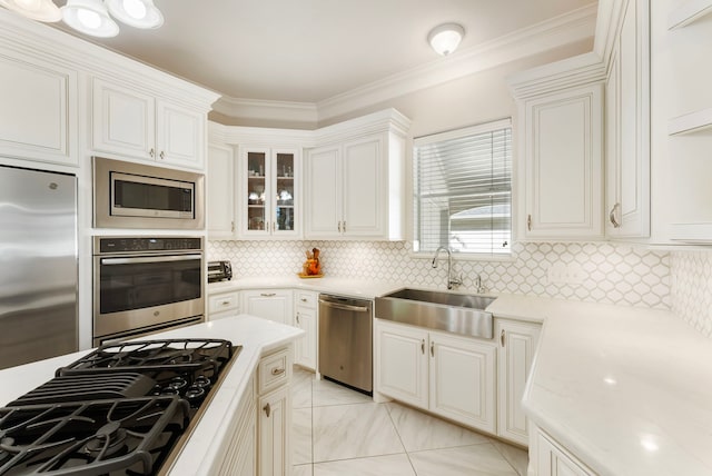 6510 Hoads Deuce Ct, Spring, TX 77379 - kitchen featuring appliances with stainless steel finishes, a sink, light countertops, decorative backsplash, and glass insert cabinets