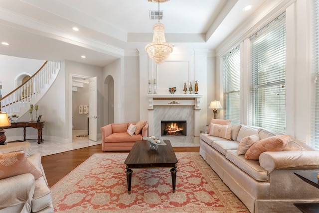 6510 Hoads Deuce Ct, Spring, TX 77379 - living room featuring arched walkways, a high end fireplace, stairs, baseboards, and recessed lighting