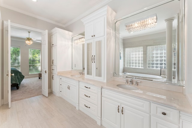 6510 Hoads Deuce Ct, Spring, TX 77379 - full bath with ornamental molding, double vanity, ensuite bath, a bath, and a chandelier
