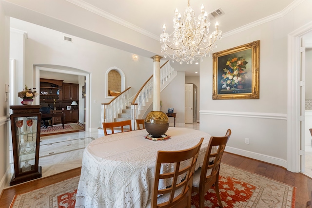 6510 Hoads Deuce Ct, Spring, TX 77379 - dining room with stairway, wood finished floors, crown molding, a chandelier, and arched walkways