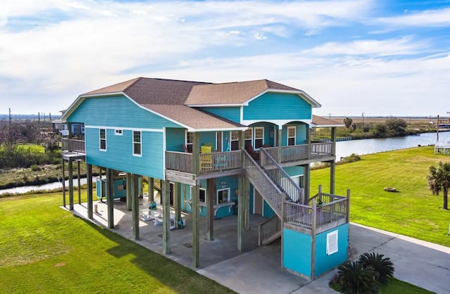 1109 Pompano Dr, Crystal Beach, TX 77650 - view of play area with a water view, a yard, a porch, and a patio