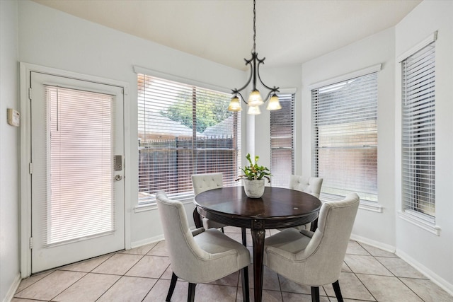 12814 Prestige Row, Houston, TX 77065 - dining room with a chandelier, light tile patterned floors, and baseboards