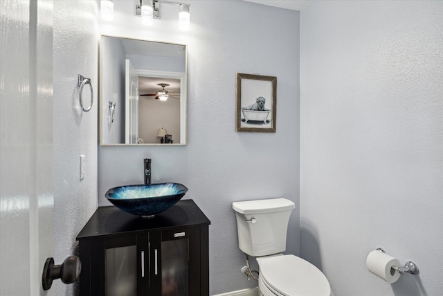 12814 Prestige Row, Houston, TX 77065 - bathroom featuring toilet, vanity, a ceiling fan, and baseboards