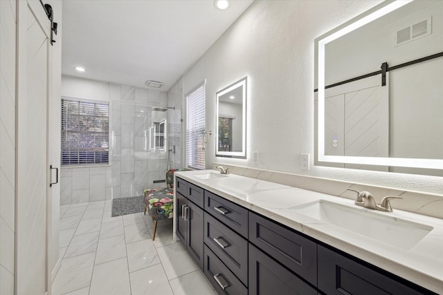 12814 Prestige Row, Houston, TX 77065 - bathroom featuring plenty of natural light, marble finish floors, a tile shower, double vanity, and recessed lighting