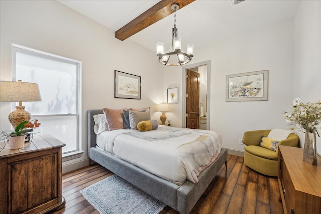 bedroom with a chandelier, beamed ceiling, dark wood-style floors, baseboards, and ensuite bathroom