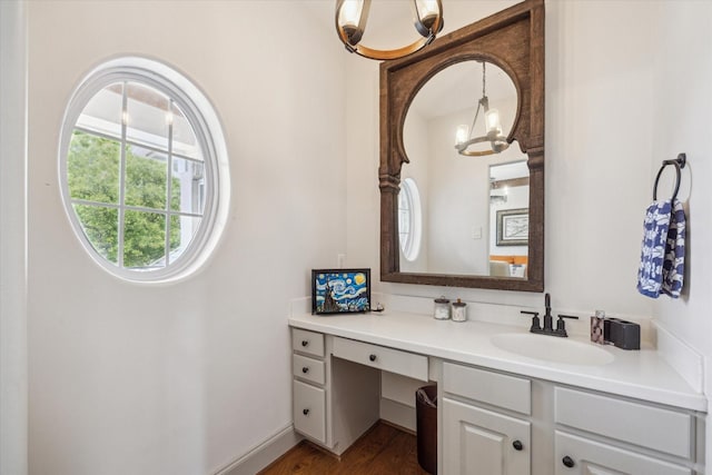bathroom featuring a chandelier, vanity, and wood finished floors