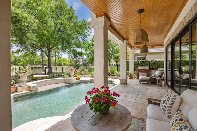 view of patio with a ceiling fan, a fenced backyard, and an outdoor living space