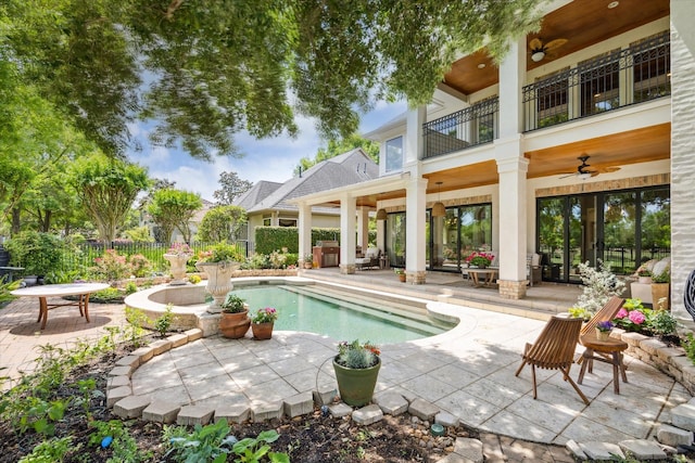 view of swimming pool featuring ceiling fan, a patio, and fence
