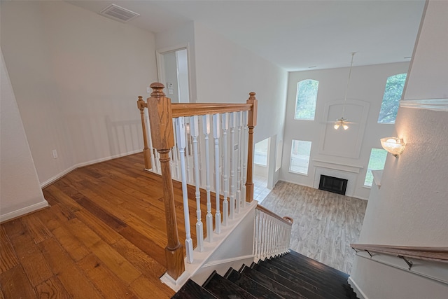 10210 Squirehill Ct, Houston, TX 77070 - staircase with hardwood / wood-style flooring, a fireplace, ceiling fan, and baseboards