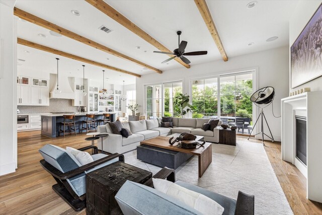 2224 N Blvd, Houston, TX 77098 - living room with ceiling fan, beamed ceiling, light wood finished floors, and recessed lighting