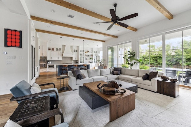 2224 N Blvd, Houston, TX 77098 - living area featuring healthy amount of natural light, beam ceiling, ceiling fan, and light wood finished floors