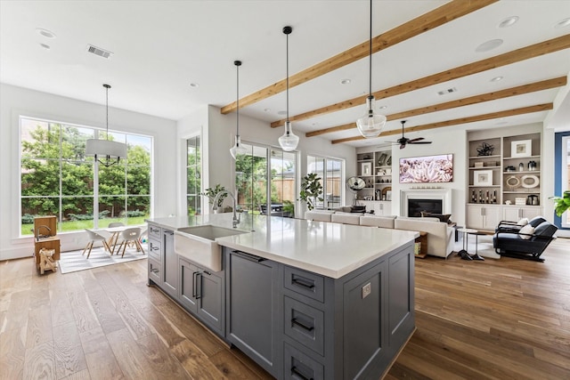 2224 N Blvd, Houston, TX 77098 - kitchen featuring a sink, gray cabinetry, ceiling fan, dark wood finished floors, and beamed ceiling