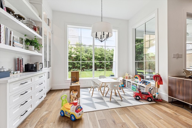 2224 N Blvd, Houston, TX 77098 - rec room with light wood-style floors, baseboards, and a chandelier