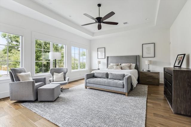 2224 N Blvd, Houston, TX 77098 - bedroom with a tray ceiling, wood finished floors, a ceiling fan, and baseboards