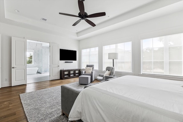 2224 N Blvd, Houston, TX 77098 - bedroom with a tray ceiling, wood finished floors, and a ceiling fan