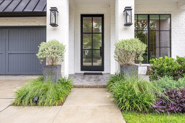 2224 N Blvd, Houston, TX 77098 - view of exterior entry featuring a porch, brick siding, and a standing seam roof