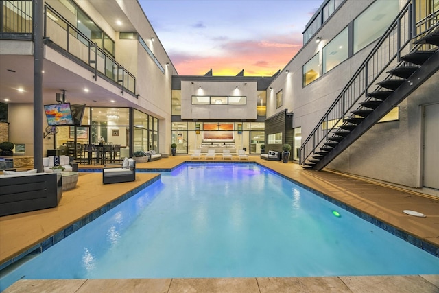 4002 Chatham Ln, Houston, TX 77027 - pool at dusk with stairway, an outdoor living space, a patio, an outdoor pool, and outdoor dining area