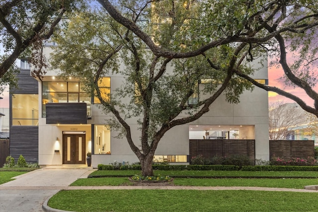 4002 Chatham Ln, Houston, TX 77027 - contemporary house with french doors, concrete driveway, and stucco siding