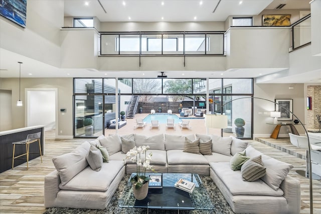 4002 Chatham Ln, Houston, TX 77027 - living area featuring a high ceiling, baseboards, and light wood-style flooring