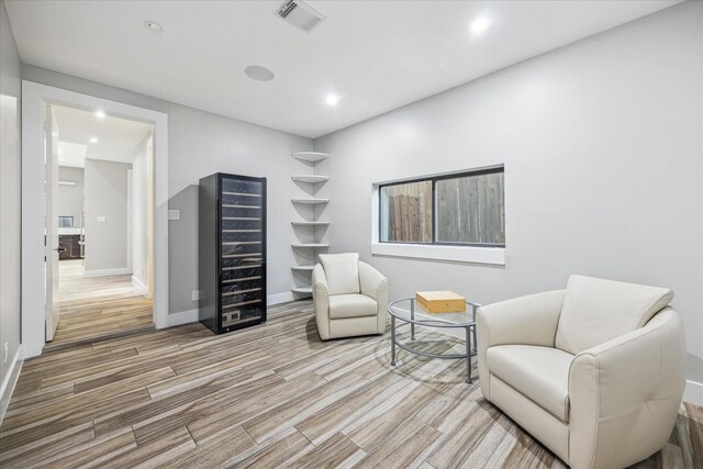 4002 Chatham Ln, Houston, TX 77027 - sitting room with beverage cooler, wood finished floors, baseboards, and recessed lighting