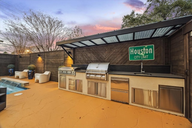 4002 Chatham Ln, Houston, TX 77027 - patio terrace at dusk with a grill, a sink, fence, and area for grilling