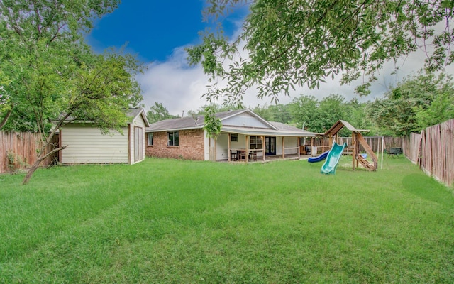 2614 Lemonwood Ln, Houston, TX 77038 - view of yard with a playground, a patio area, and an outbuilding