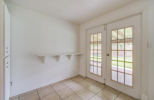 2614 Lemonwood Ln, Houston, TX 77038 - doorway to outside with light tile patterned flooring, baseboards, french doors, and a textured ceiling
