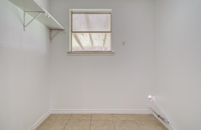 2614 Lemonwood Ln, Houston, TX 77038 - clothes washing area with baseboards and light tile patterned floors