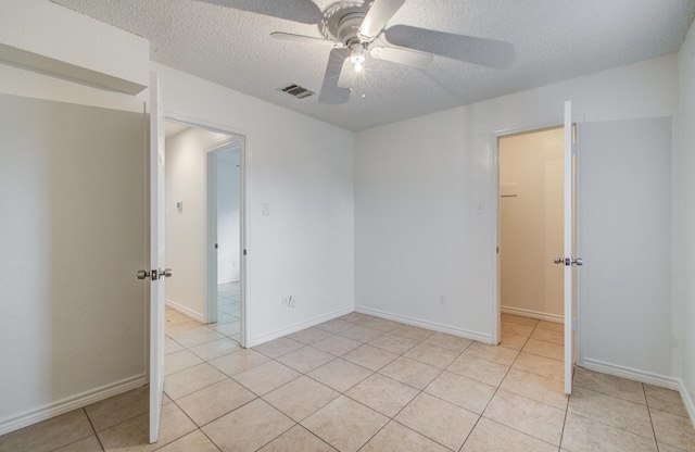 2614 Lemonwood Ln, Houston, TX 77038 - spare room featuring a ceiling fan, a textured ceiling, light tile patterned floors, and baseboards