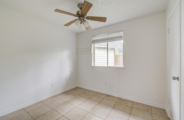 2614 Lemonwood Ln, Houston, TX 77038 - unfurnished room featuring light tile patterned floors, baseboards, a ceiling fan, and a textured ceiling