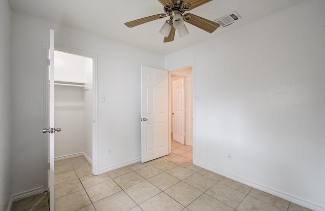 2614 Lemonwood Ln, Houston, TX 77038 - unfurnished bedroom with a spacious closet, light tile patterned floors, a closet, and baseboards