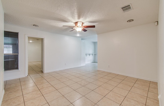 2614 Lemonwood Ln, Houston, TX 77038 - unfurnished room featuring a ceiling fan, a textured ceiling, light tile patterned flooring, and baseboards