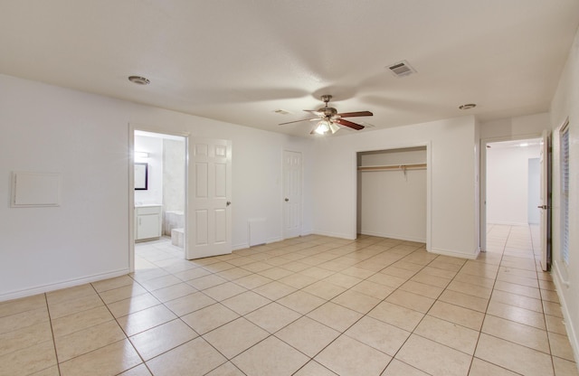 2614 Lemonwood Ln, Houston, TX 77038 - unfurnished bedroom with light tile patterned flooring, a closet, a ceiling fan, and baseboards
