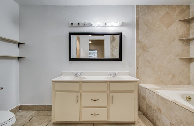 2614 Lemonwood Ln, Houston, TX 77038 - full bathroom featuring tile patterned floors, double vanity, tiled bath, toilet, and baseboards