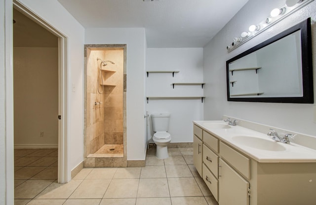 2614 Lemonwood Ln, Houston, TX 77038 - bathroom with toilet, tile patterned flooring, tiled shower, double vanity, and baseboards