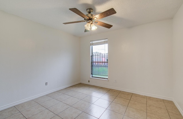 2614 Lemonwood Ln, Houston, TX 77038 - unfurnished room with light tile patterned flooring, baseboards, ceiling fan, and a textured ceiling